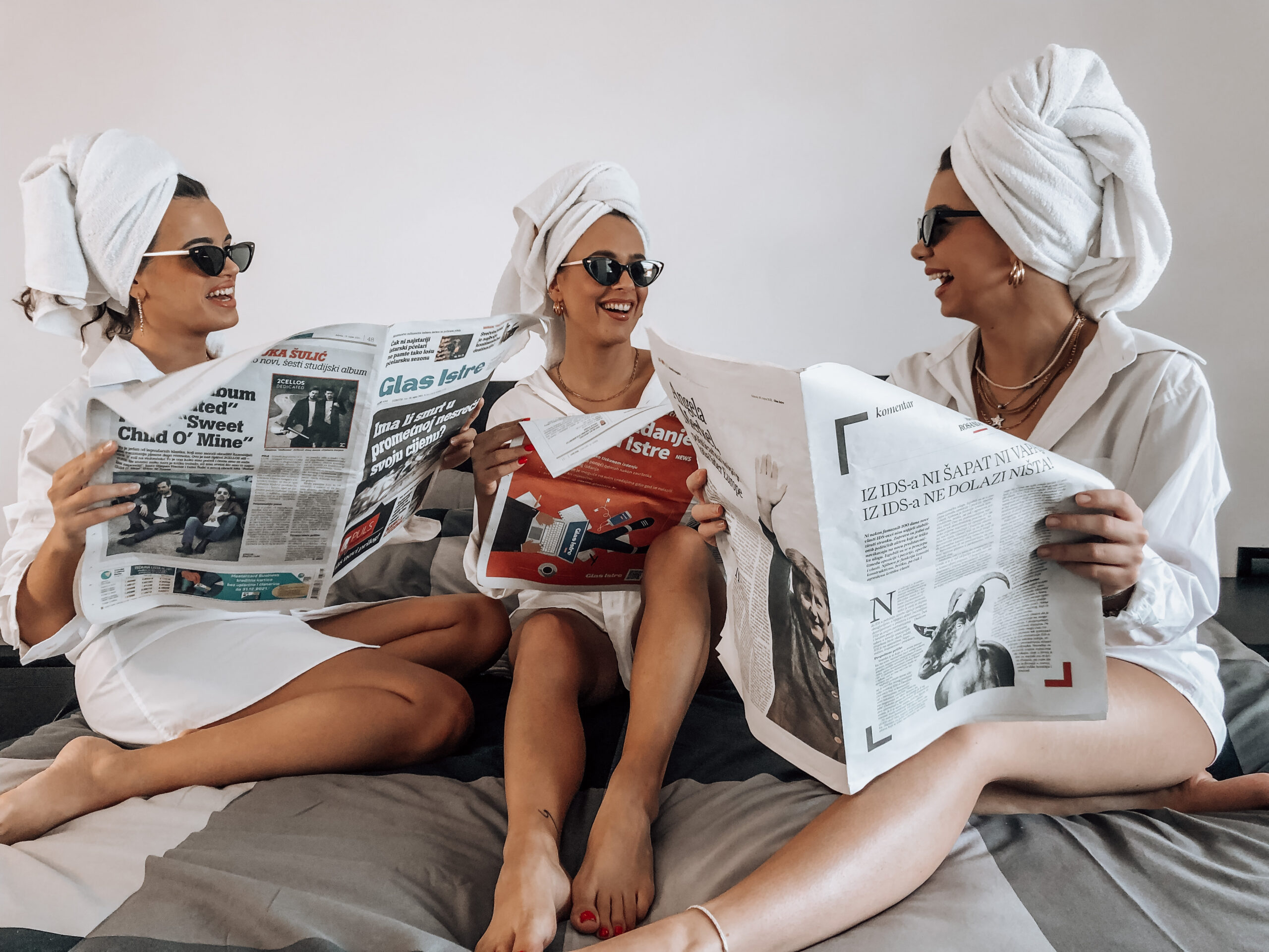 girls talking to each other with newspapers